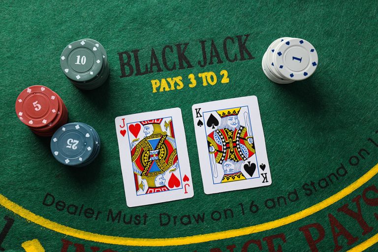 Blackjack table with cards and casino chips illustrating the question “Is It Illegal To Count Cards?” in a real casino setting.